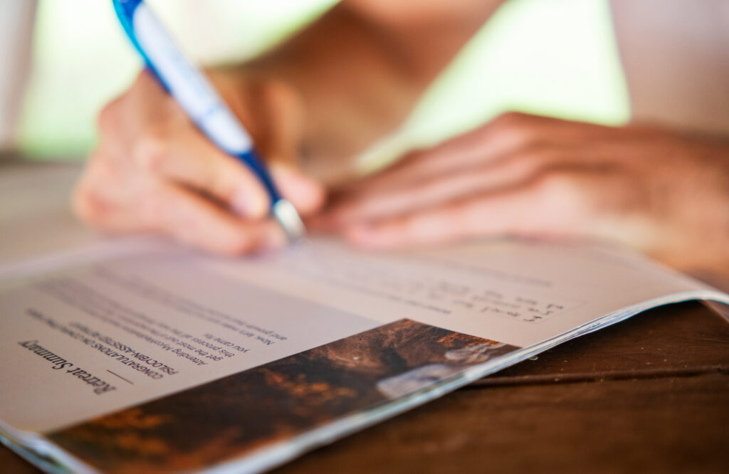 person writing psychedelic integration notes in workbook
