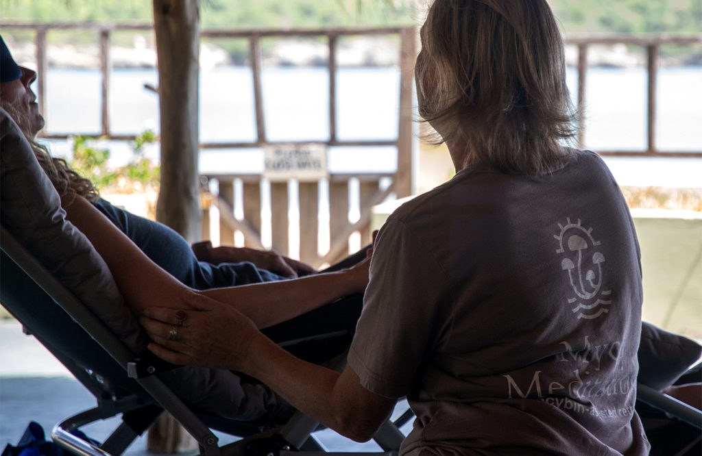 woman in chair receiving psilocybin therapy at mycomeditations