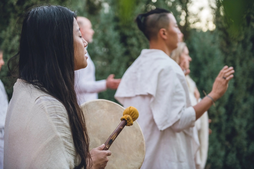 People chanting and drumming in a New Age-style psilocybin mushroom ceremony.