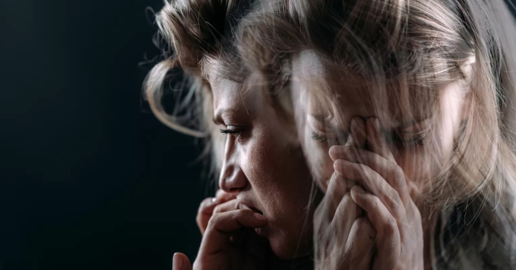 A layered image of a woman with different layers of different expressions that show she's suffering.